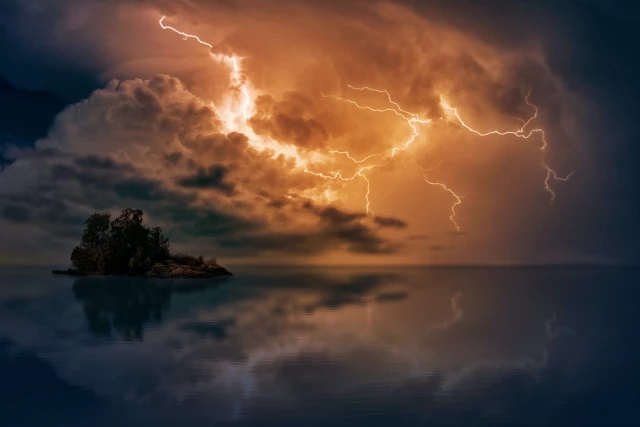 Sea at night with dark clouds and bright lightning